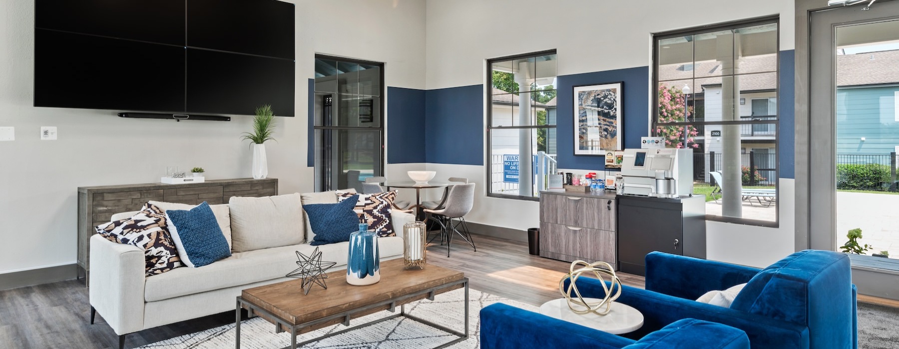 a clubroom with a tv, couch and chairs