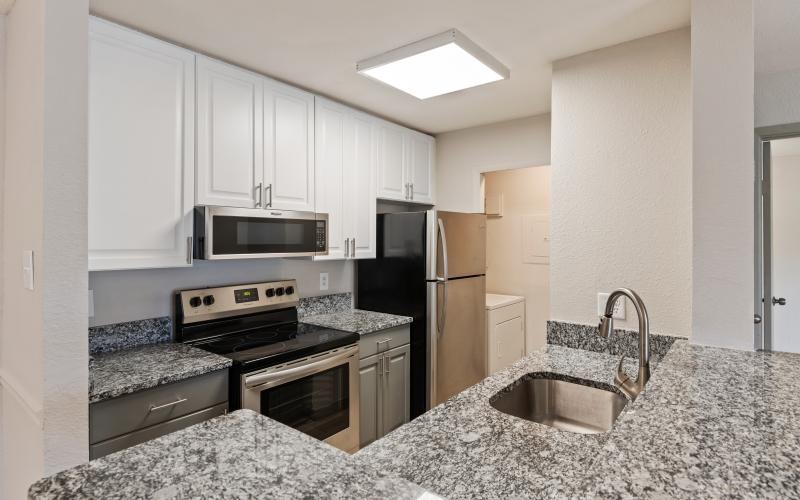 a kitchen with white cabinets