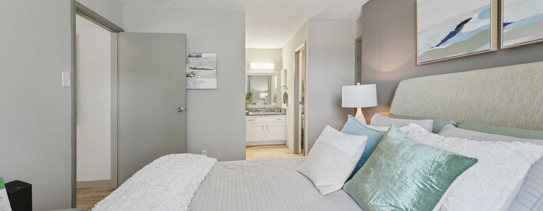 a bedroom with a bed and lamps